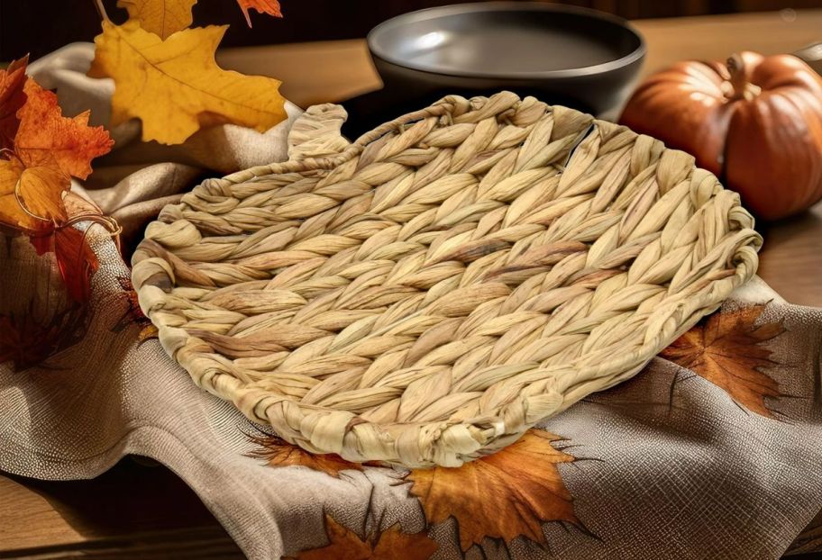 a woven wicker pumpkin tray on a tabletop