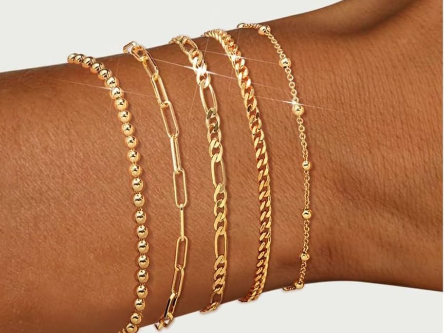 a woman wearing adoyi stackable gold bracelets for women