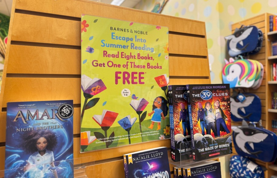 summer reading program sign hanging on a barnes and noble book display