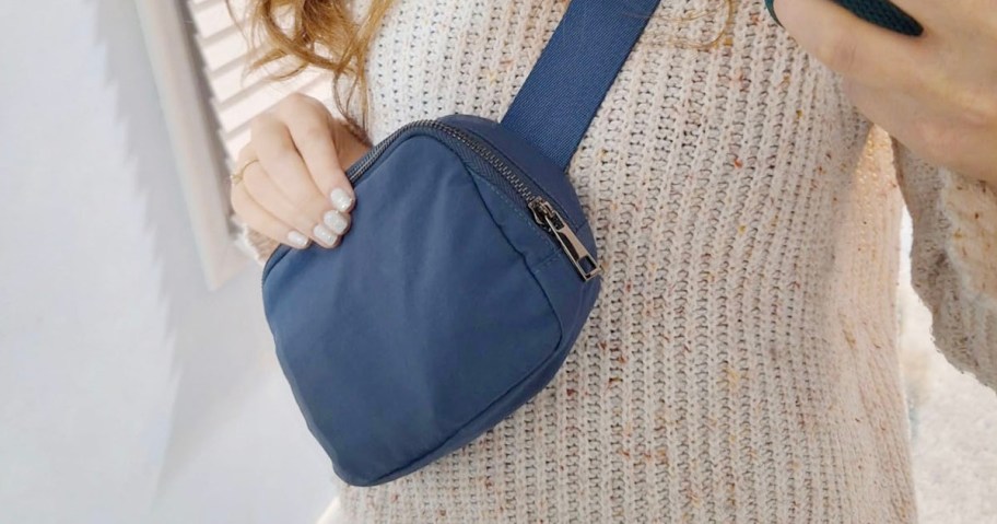 woman wearing navy blue belt bag