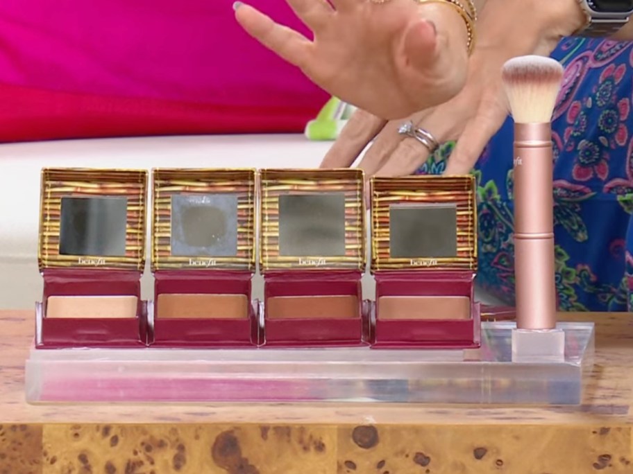 many bronzers in a row next to brush