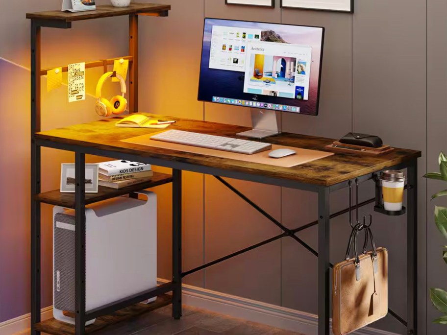 brown and black gaming desk with onlineputer and other items on it