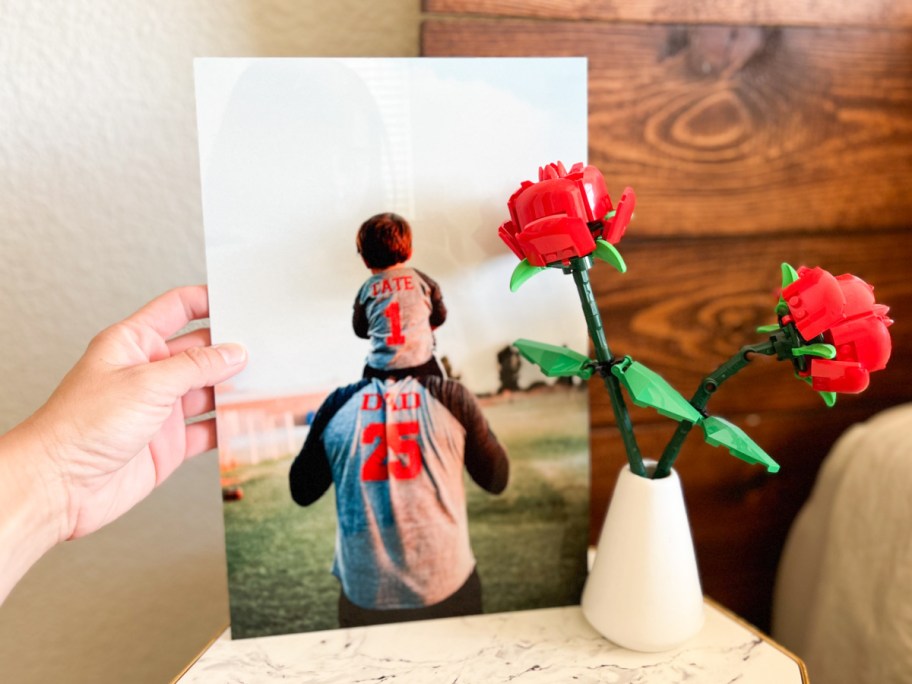 hand holding metal print next to lego roses