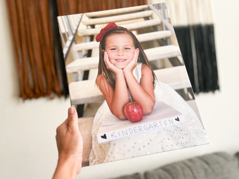 hand holding canvas with school picture