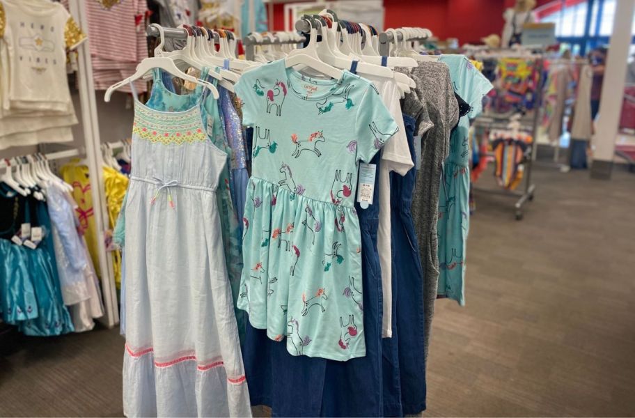 cat and jack girls dresses hanging in a target store