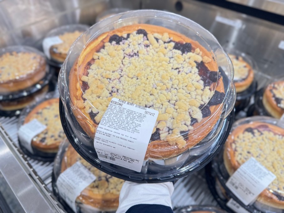 hand holding mixed berry streusel in container