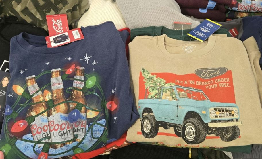 mens coor's and ford bronco logo holiday sweatshirts on a display table in a store