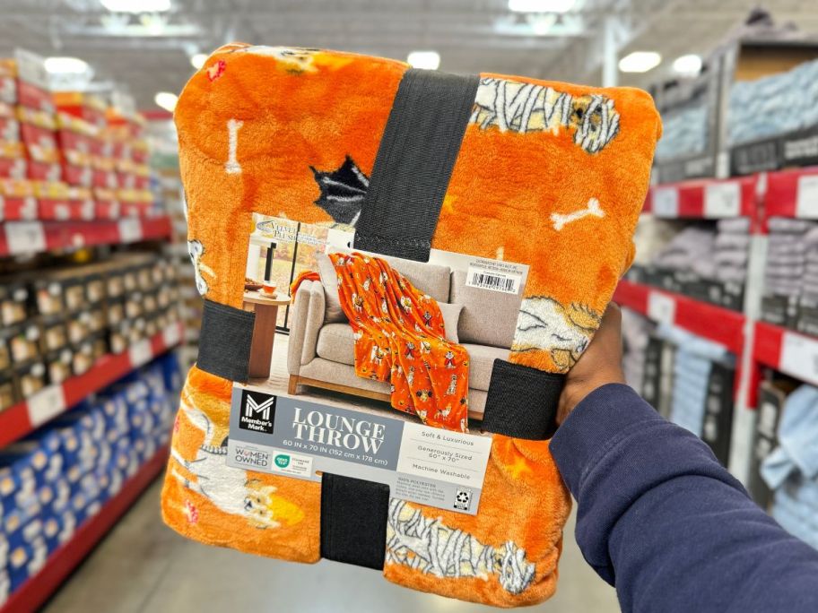 Member's Mark Lounge 60" x 70" Throws in Halloween Designs - Costume Canines in hand in store