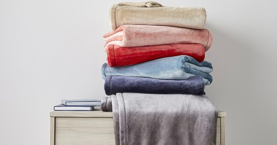 stacked blankets on dresser 