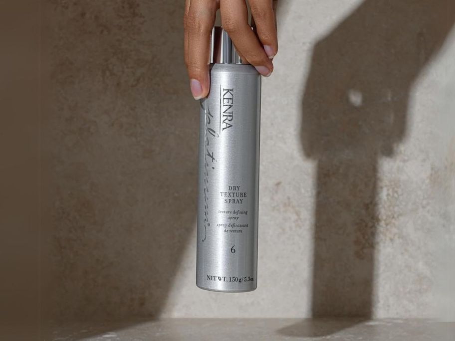 hand holding Kenra Platinum Dry Texture Spray 5.3oz from top