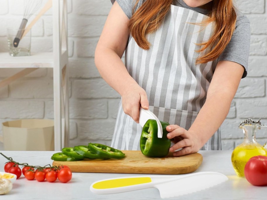 kid cutting veggies with safe knife