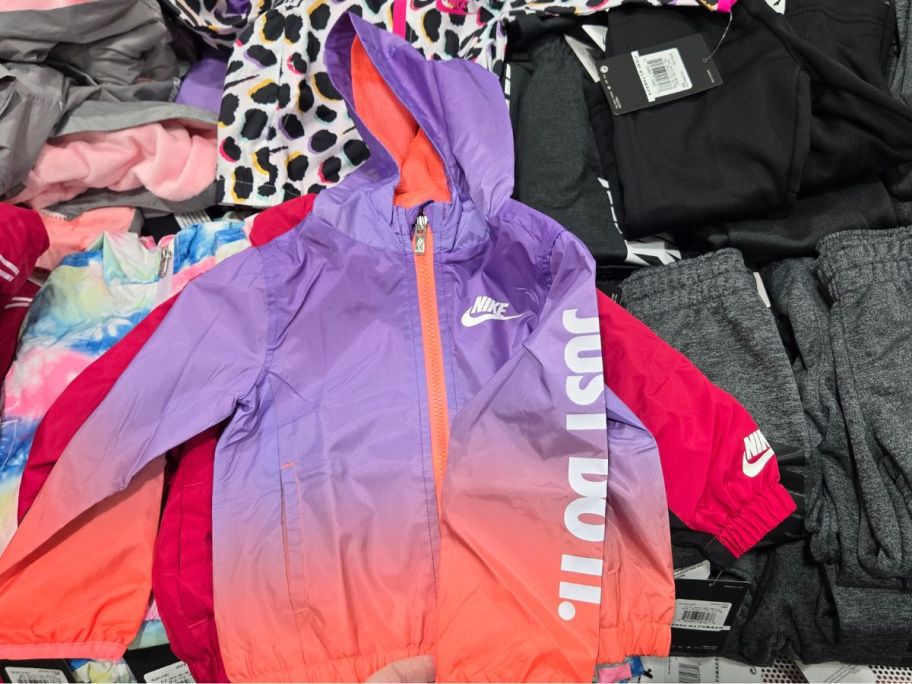 a purple and orange kids nike wind jacket