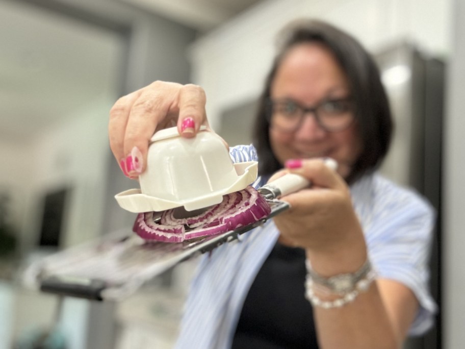 lina holding slicer on red onion