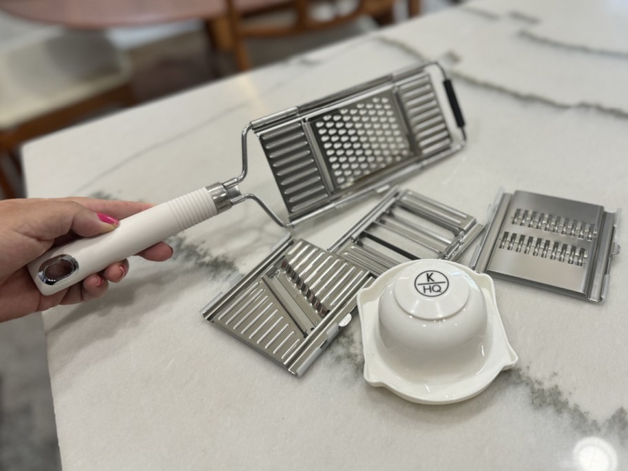 hand holding grater next to attachments