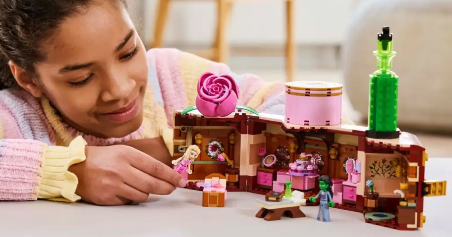 girl playing with lego wicked dorm set on table