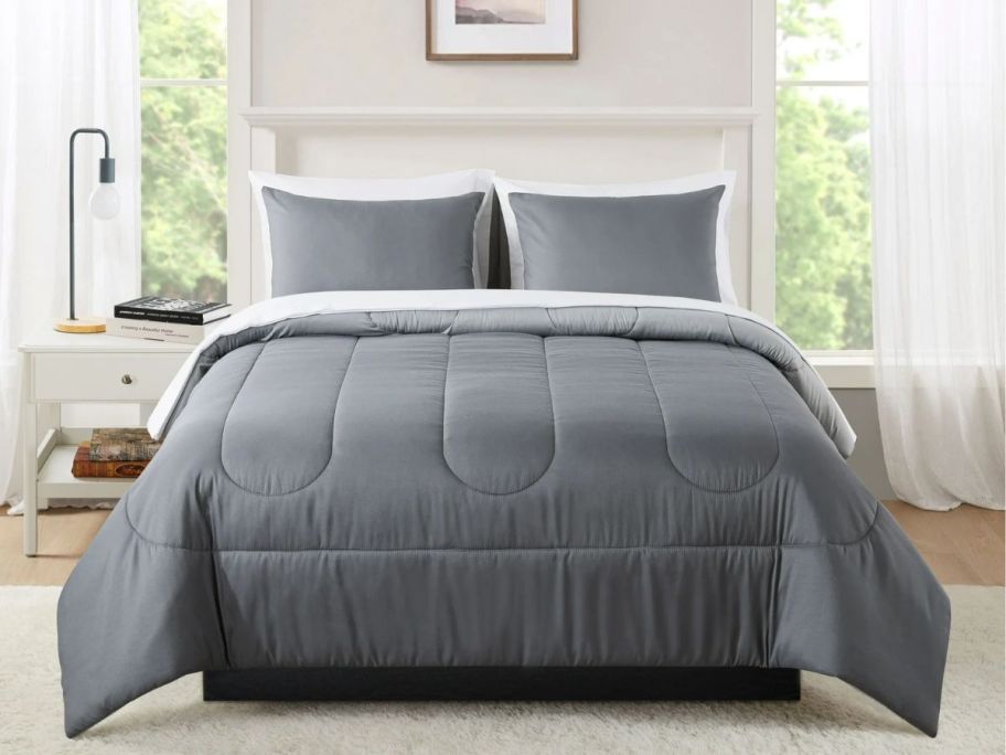 a bed featuring a gray 7 piece bed in a bag set