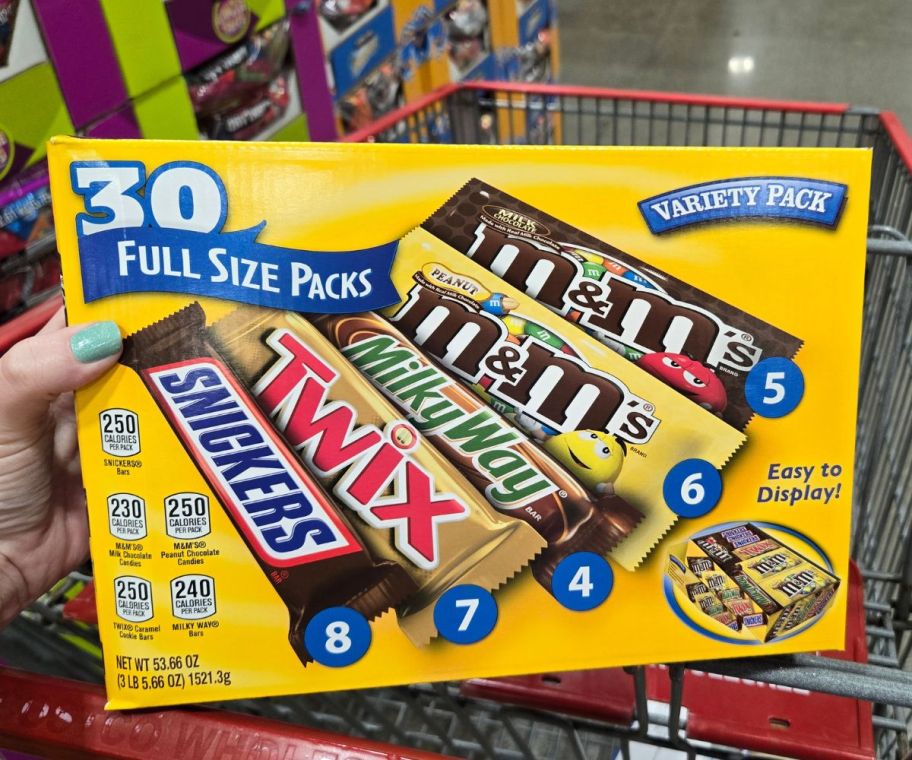 a woman's hand holding a 30 count variety box of mars chocolate candies