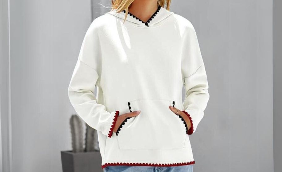 a model wearing Merokeety Women's Hoodies in white