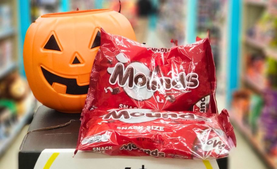 two bags of mounds snack size candy bars shown with a jack o lantern candy pail