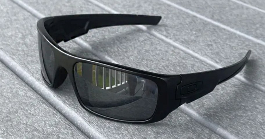 pair of black oakley sunglasses sitting on table