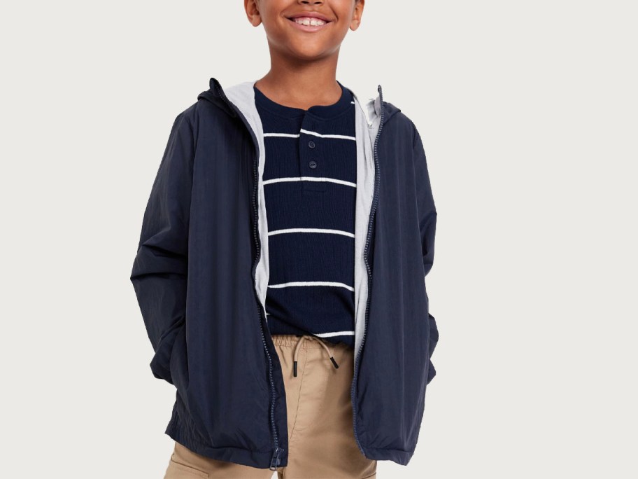 boy wearing navy blue jacket and khakis