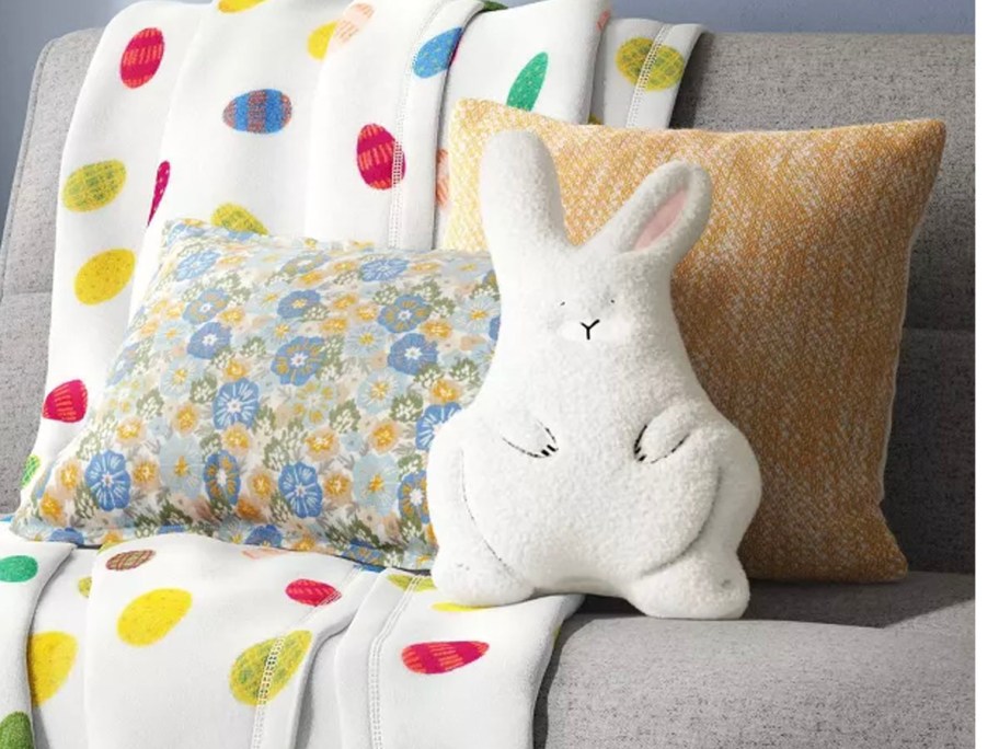 floral pillow with white bunny pillow on couch