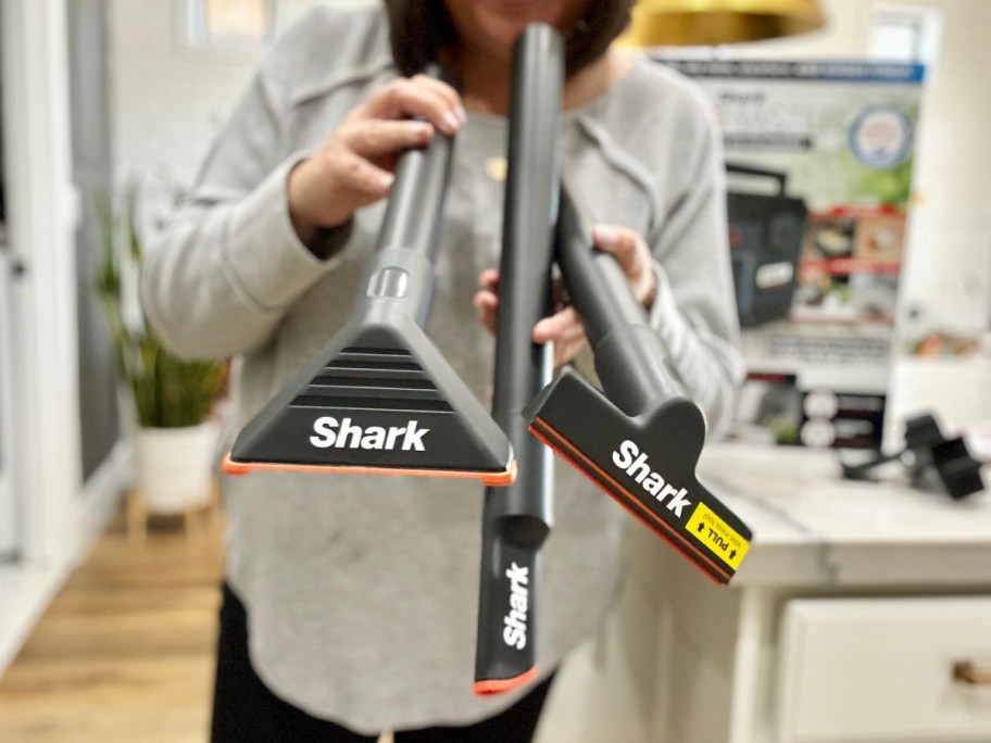 woman holding vacuum attachments