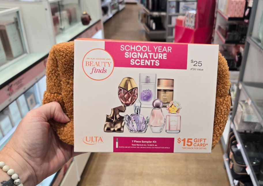 a womans hand holding a back to school signature scents sampler kit in an ulta store