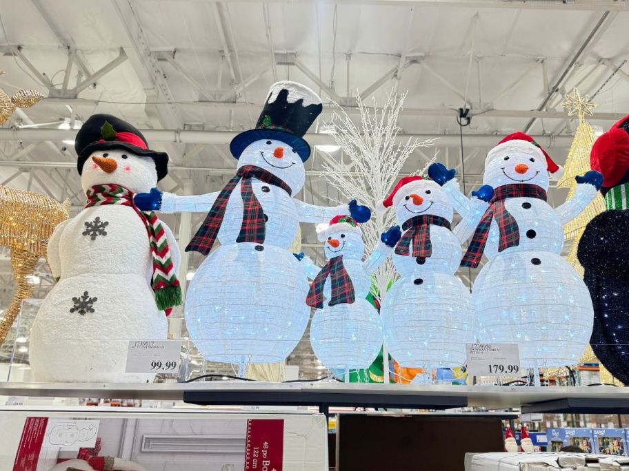 snowman family on display in a costco store