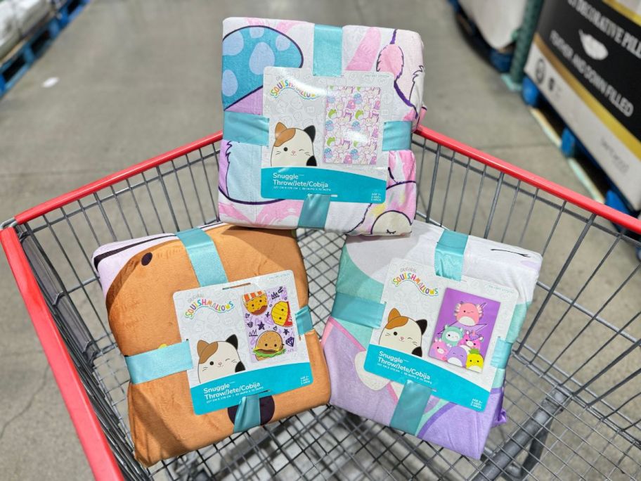 three squishmallows throws in a costco cart