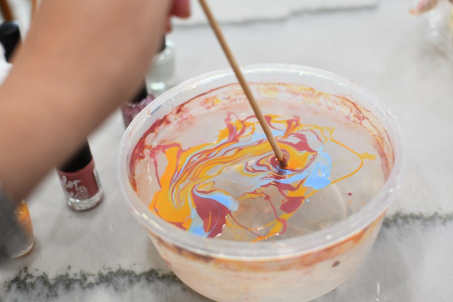 swirling nail polish on top of water