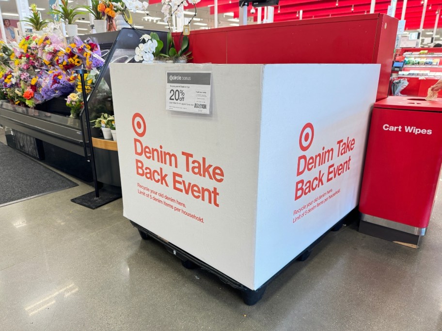 large white box at Target with Target logo that says "Denim Take Back Event" and a sign with 20% off