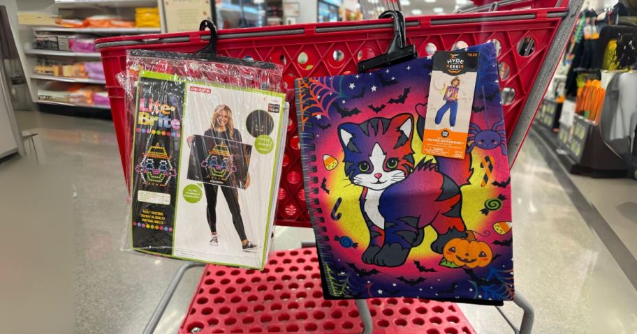 two halloween costumes hanging on cart in store