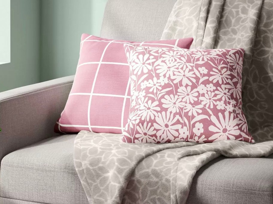 two pink throw pillows on couch