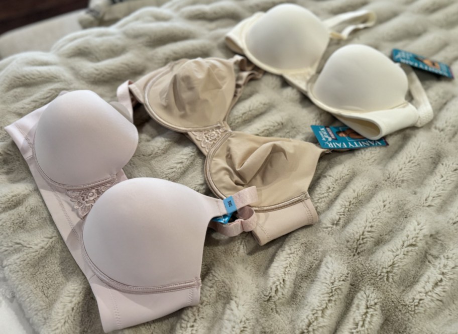 three neutral bras on blanket