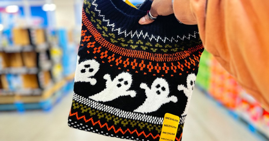 hand holding ghost halloween sweater