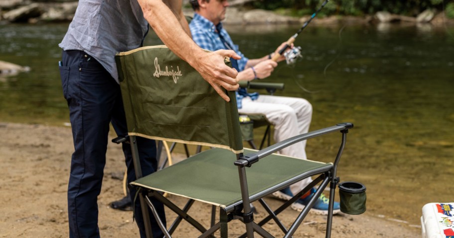 man opening green slumberjack chair