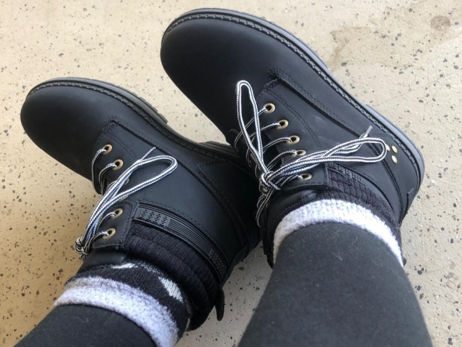 woman showing hike boots in black