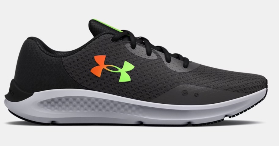 a black and grey men's Under Armour running shoe with orange and yellow accents