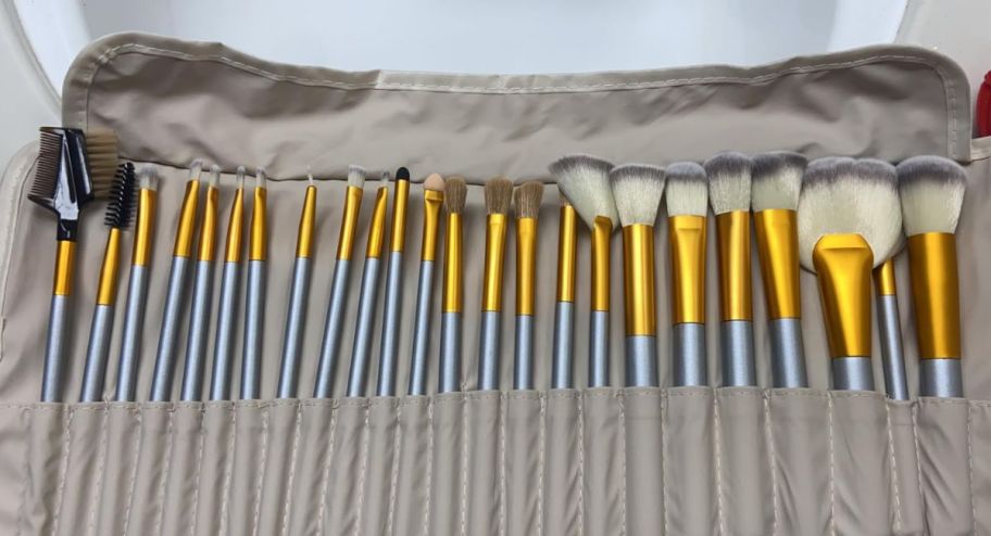 a 24-piece makeup brush set in an opened carry case on a tabletop