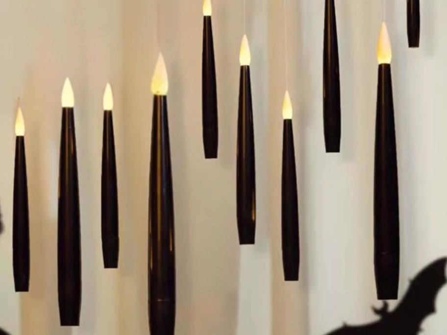 black floating candles hanging in a room