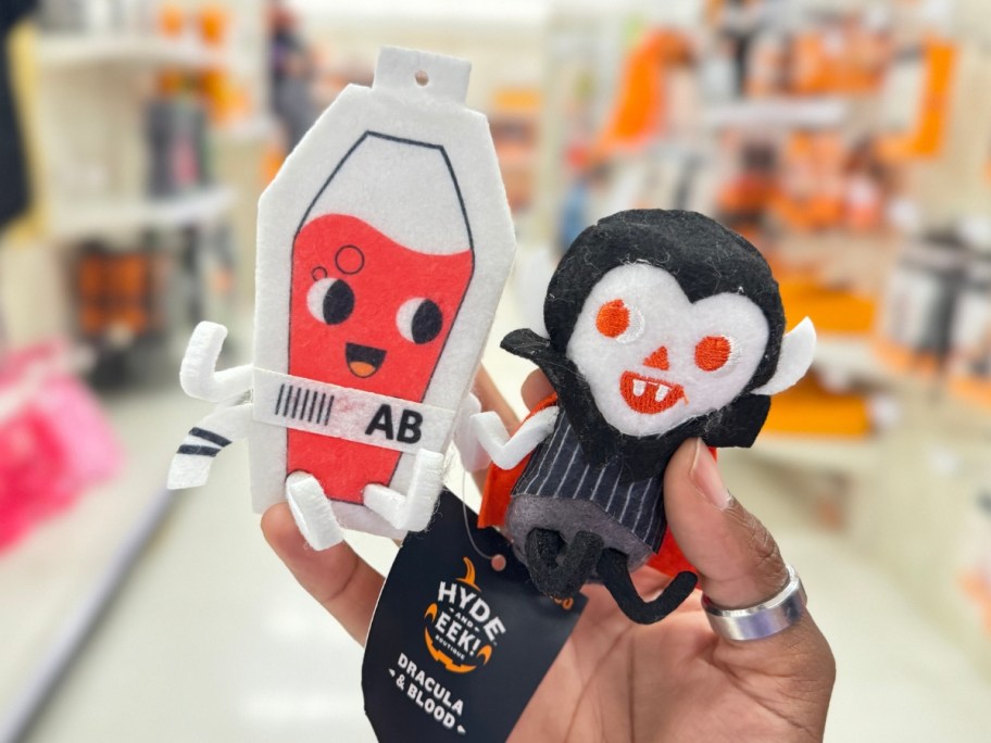 hand holding a felt duo set of a blood bag and a Dracula