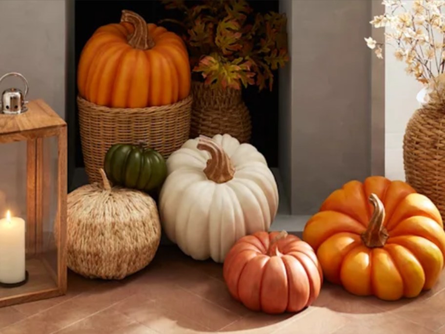 fireplace with decorative pumpkins in various sizes, shapes, and colors