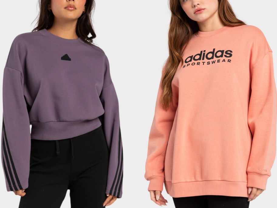 woman wearing a purple cropped adidas hoodie and woman wearing a peach orange oversized adidas hoodie