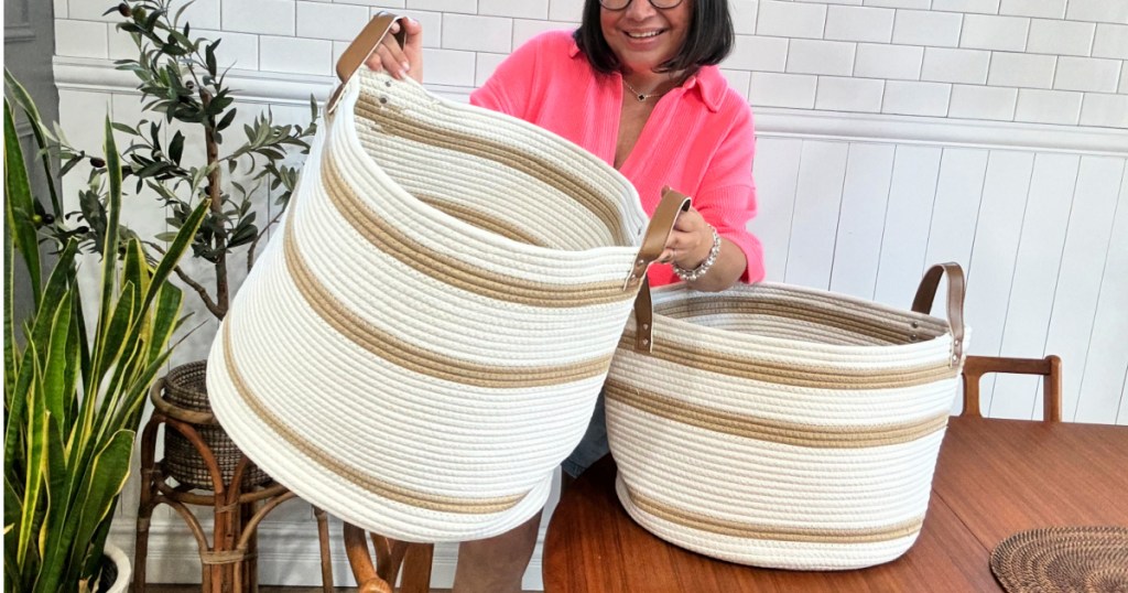 woman holding beige and tan rope basket with smaller basket on table