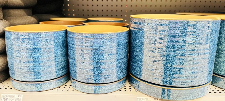 small and large blue planters on store shelf