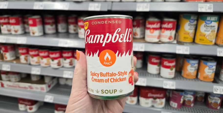 hand with a can of Campbells Spicy Buffalo Style Cream of Chicken Soup