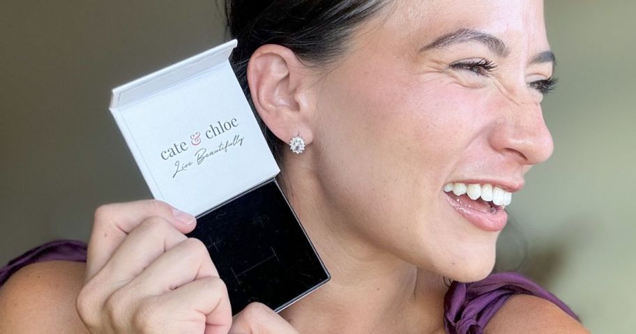 Woman holding a Cate & Chloe Box next to a pair of Sage Wisdom Earrings