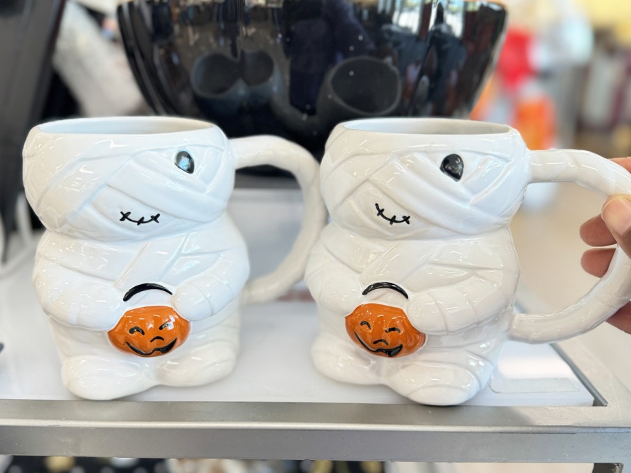 two halloween mummy mugs on store shelf