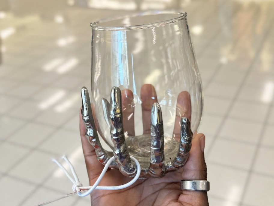 stemless wine glass with skeleton hand on bottom